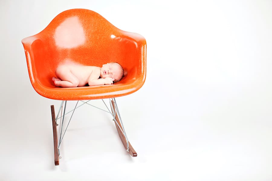 snuggly little guy in mid-century newborn session