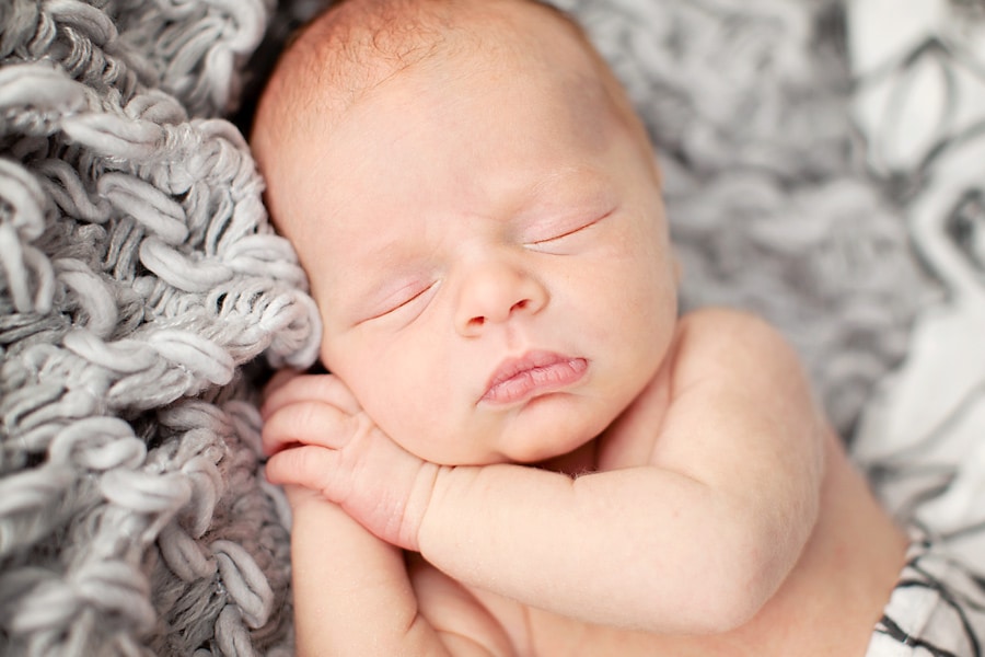 snuggly little guy in mid-century newborn session