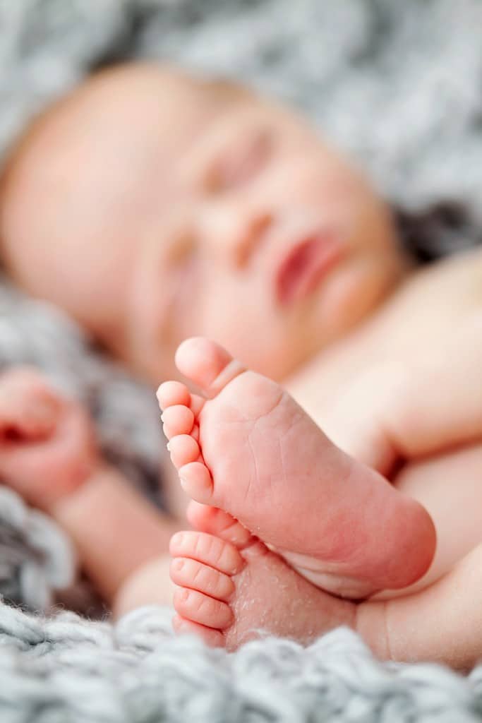 snuggly little guy in mid-century newborn session