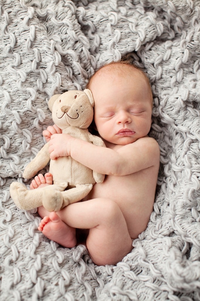 snuggly little guy in mid-century newborn session