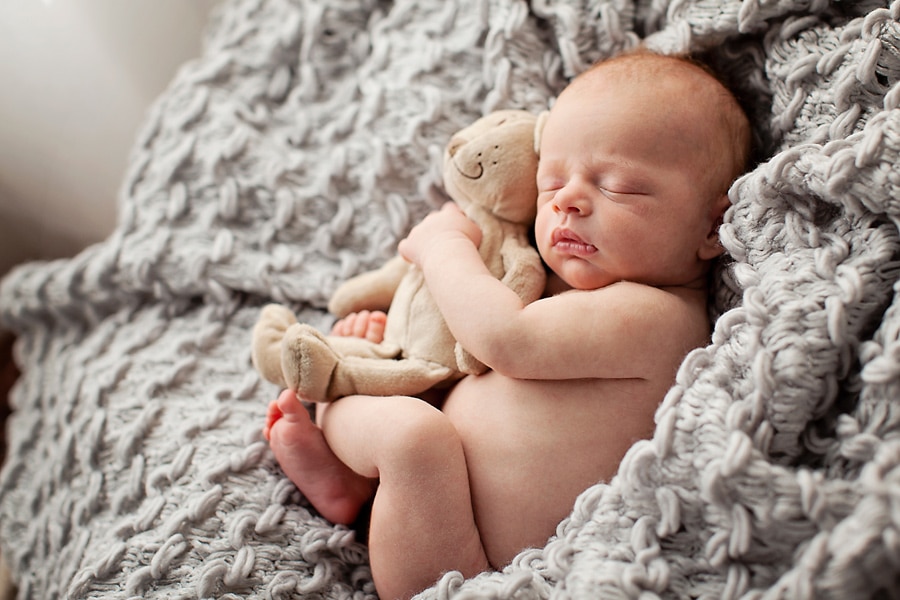 snuggly little guy in mid-century newborn session