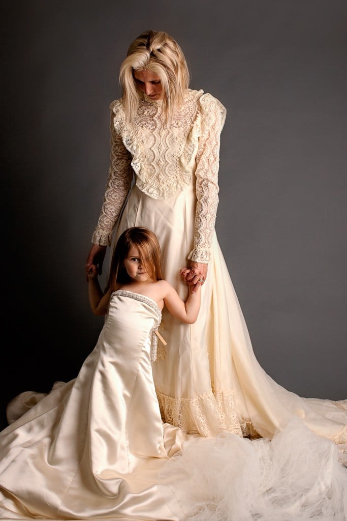 mom and daughter wearing generations of wedding dresses in sentimental photoshoot