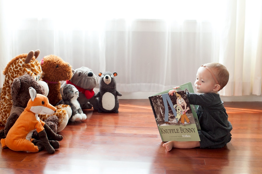 beautiful little girl posing with peony in private studio