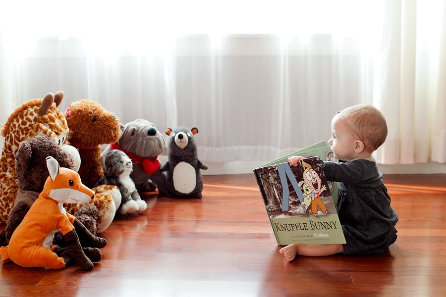 beautiful little girl posing with peony in private studio