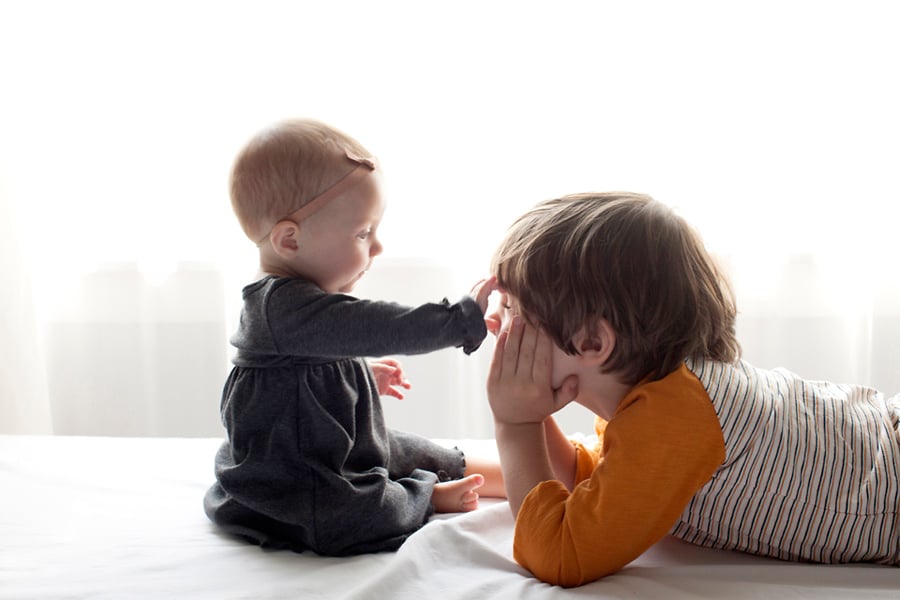 beautiful little girl posing with peony in private studio