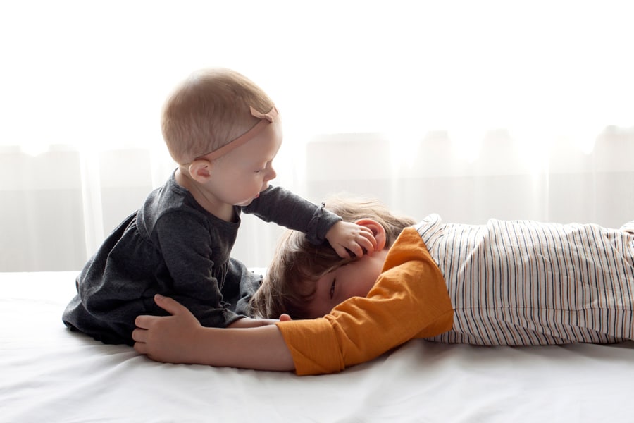 beautiful little girl posing with peony in private studio