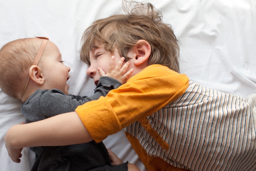 beautiful little girl posing with peony in private studio