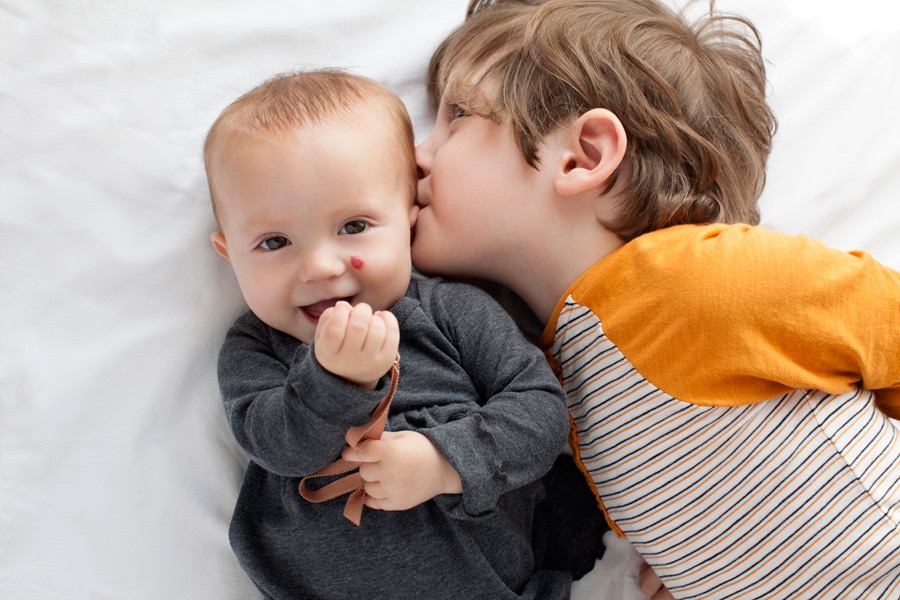 beautiful little girl posing with peony in private studio