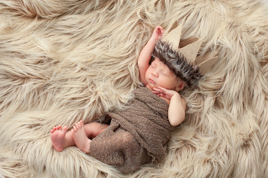 beautiful newborn baby boy snuggled up for photoshoot in private Dallas Studio session