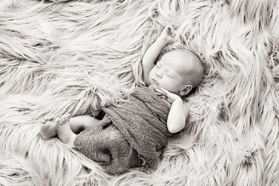 beautiful newborn baby boy snuggled up for photoshoot in private Dallas Studio session