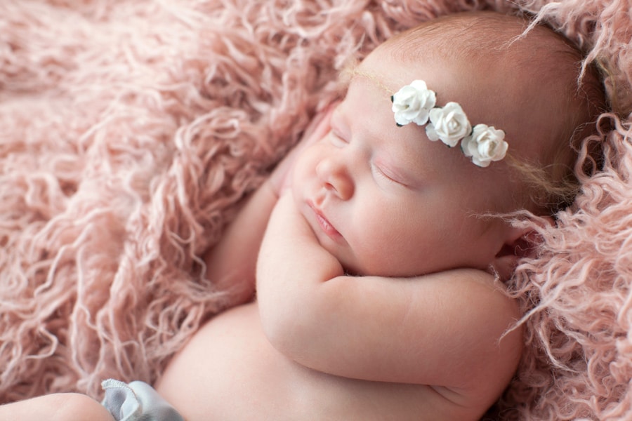 cutest newborn baby girl posing snuggled up in Dallas Studio