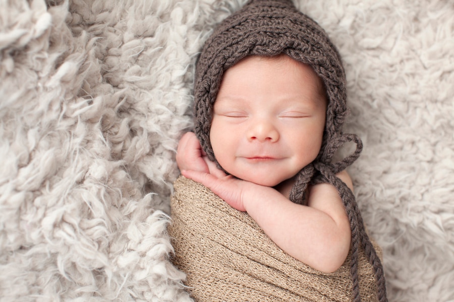 beautiful newborn baby posing in private studio session with parents