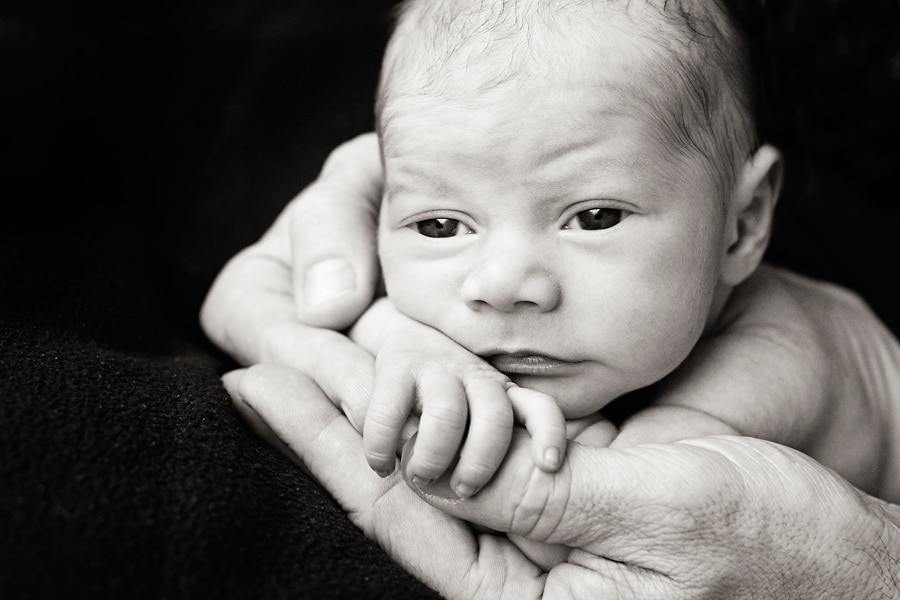 beautiful newborn baby posing in private studio session with parents