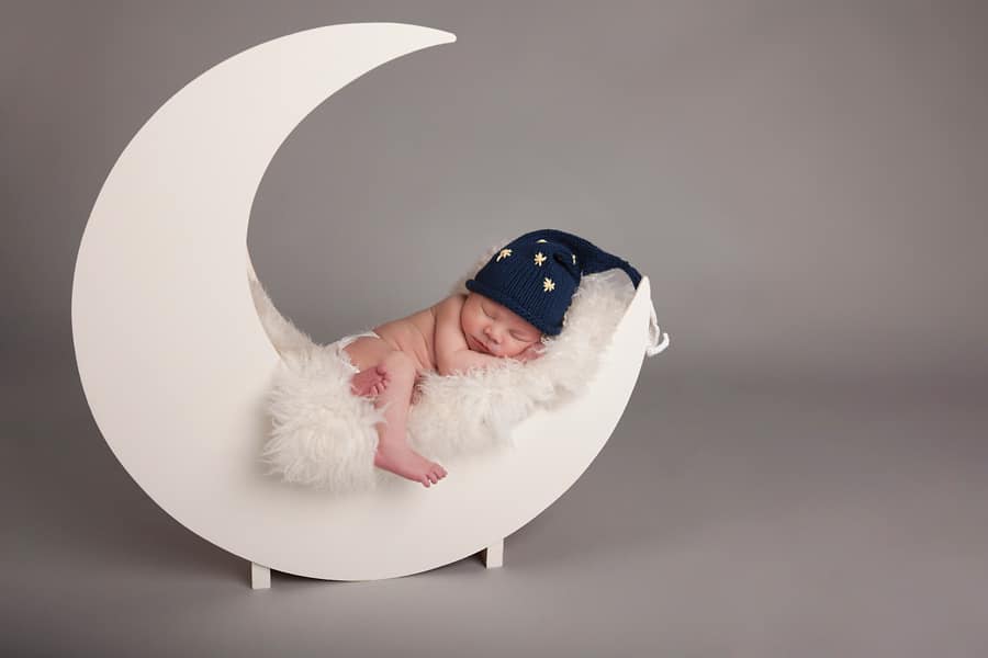 beautiful newborn baby posing in private studio session with parents