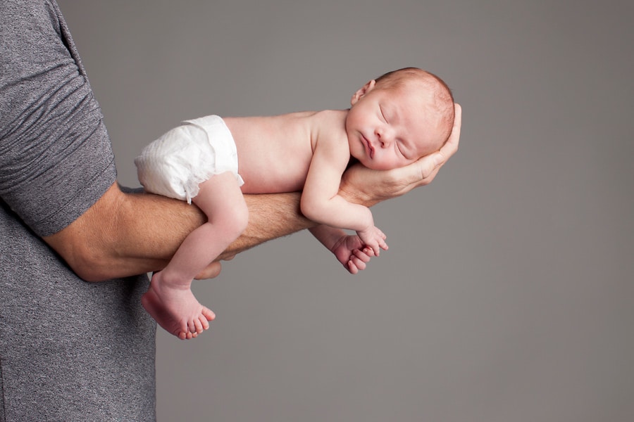 beautiful newborn baby posing in private studio session with parents