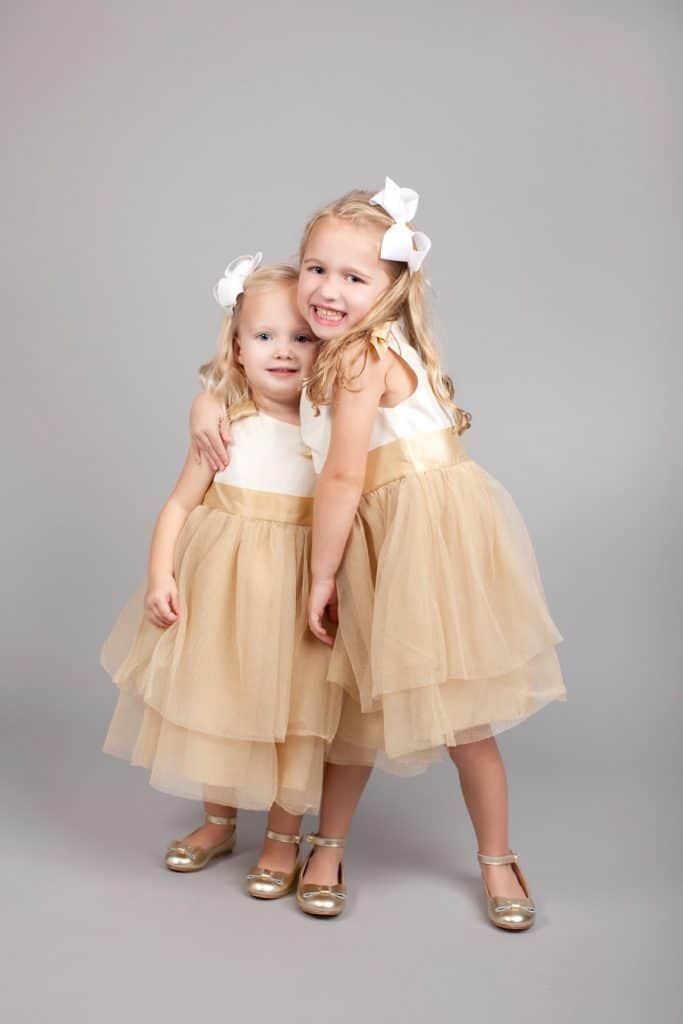 adorable sister siblings photos wearing matching outfits in private Dallas Studio