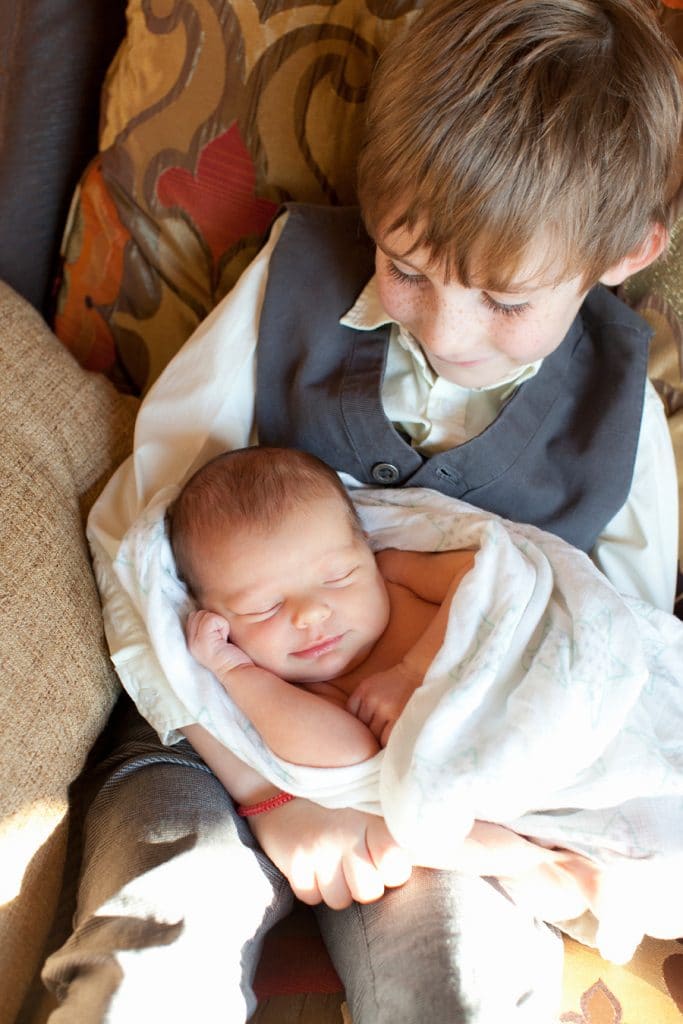 in-home newborn session with the cutest baby posing