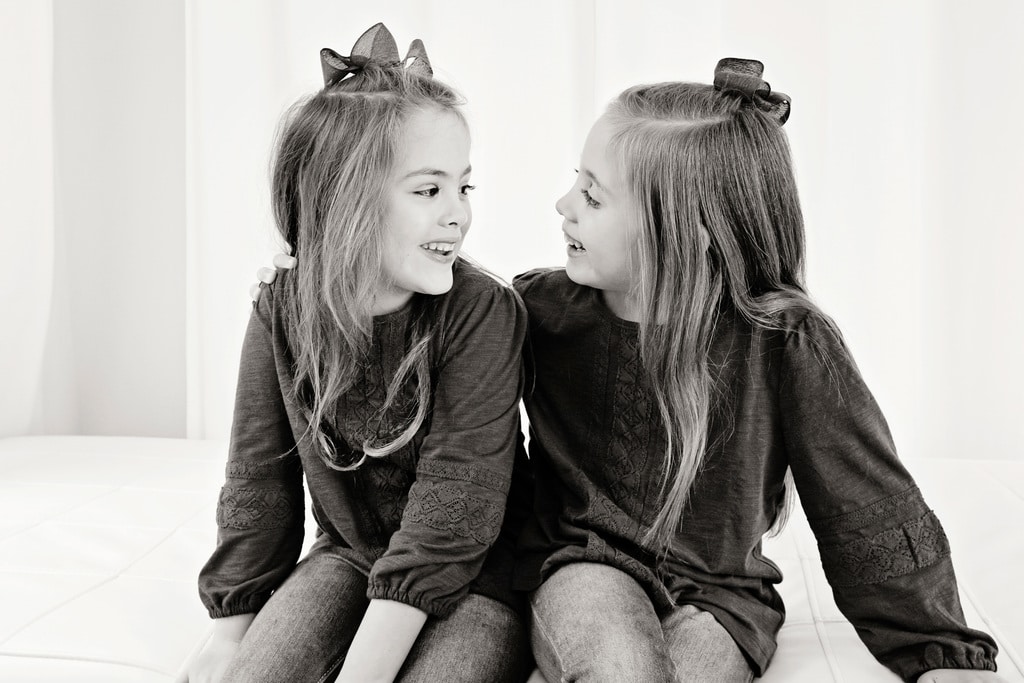 adorable sisters posing in private Dallas Studio