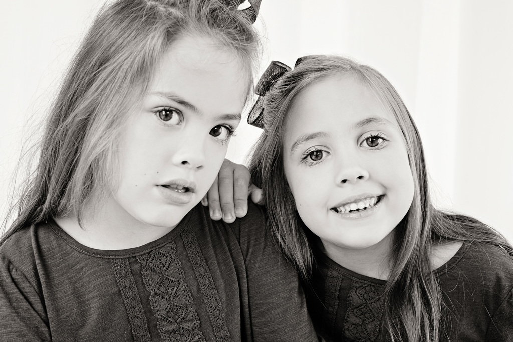 adorable sisters posing in private Dallas Studio