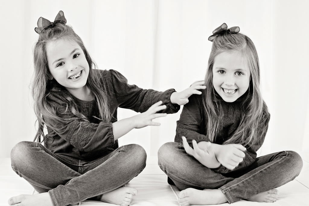 adorable sisters posing in private Dallas Studio