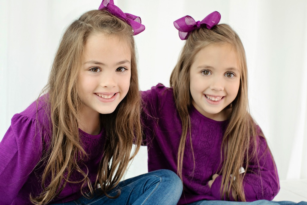 adorable sisters posing in private Dallas Studio