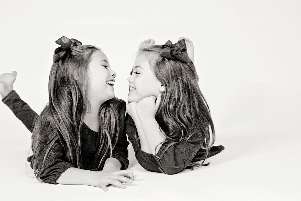 adorable sisters posing in private Dallas Studio