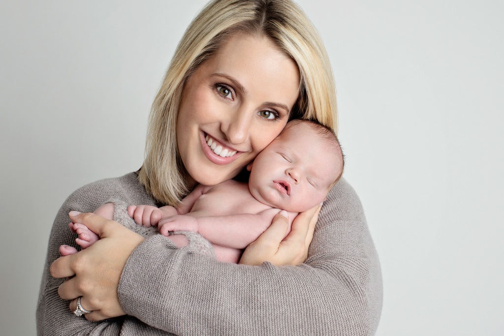 sweet mom loving on her newborn baby during family session