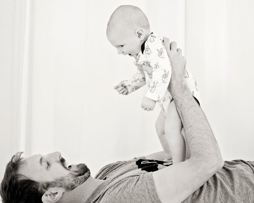 mom and dad showing off baby in private studio session