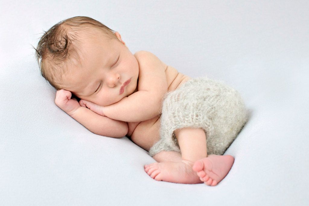 gorgeous sleepy newborn snoozing in studio 