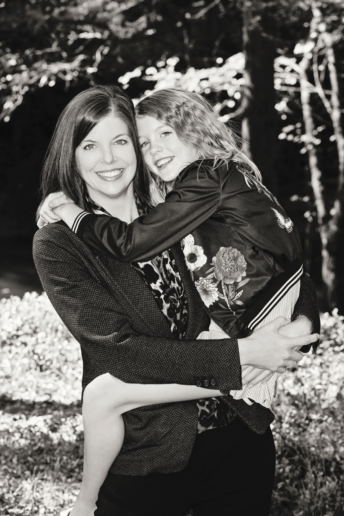 mom and daughter snuggle up for family photos