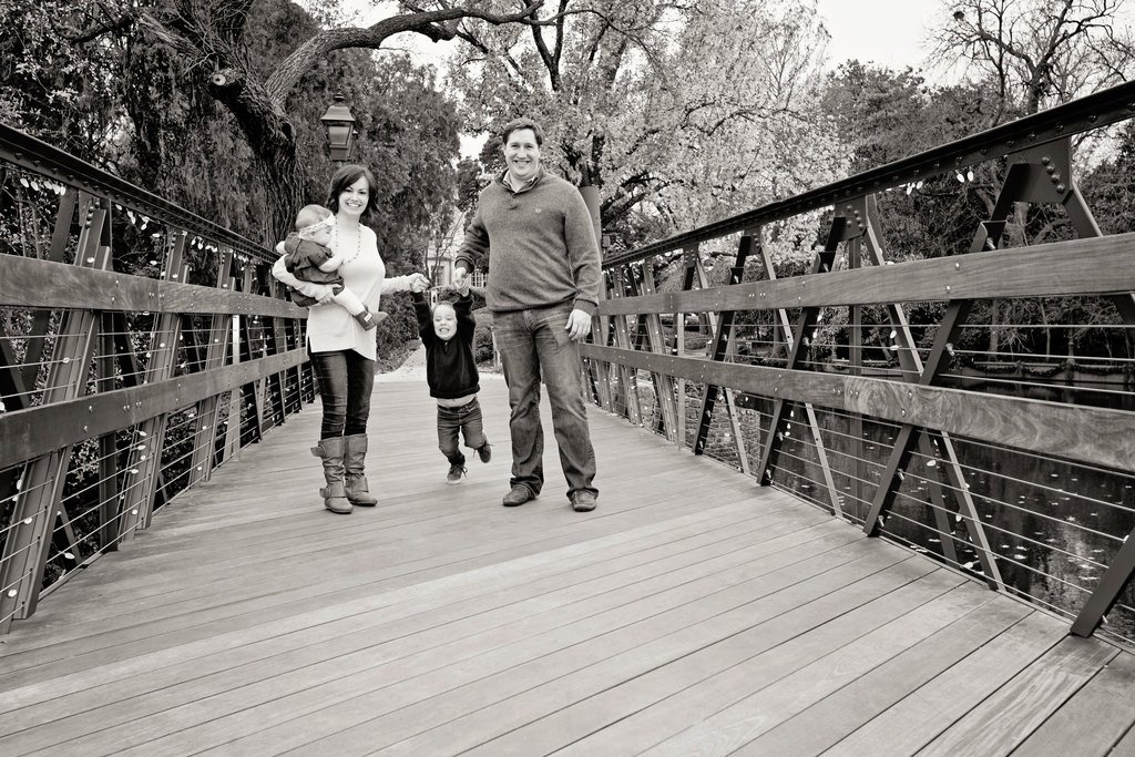 beautiful family of four poses outside for memorable photos