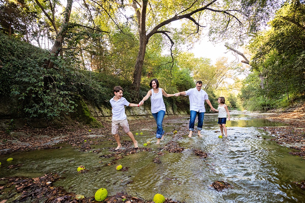 kids play outside for family session in creek