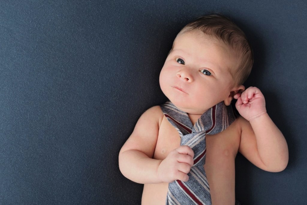 adorable baby boy in dad's tie for first photoshoot