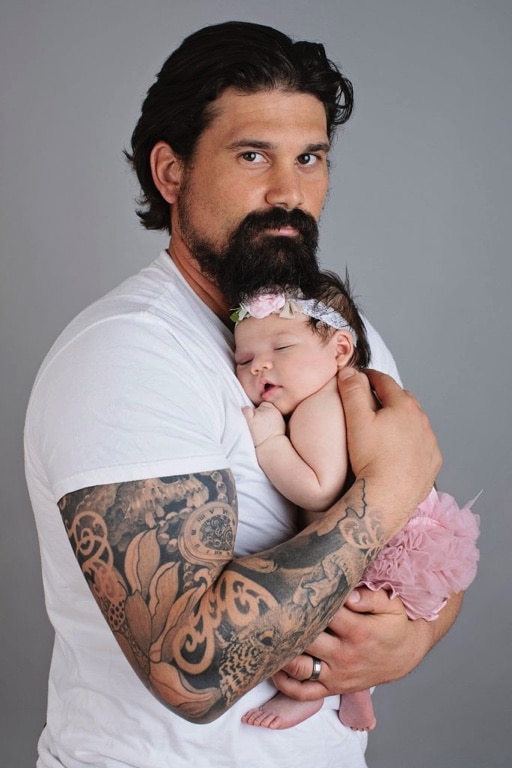 tattooed dad holds newest princess in private dallas studio newborn session