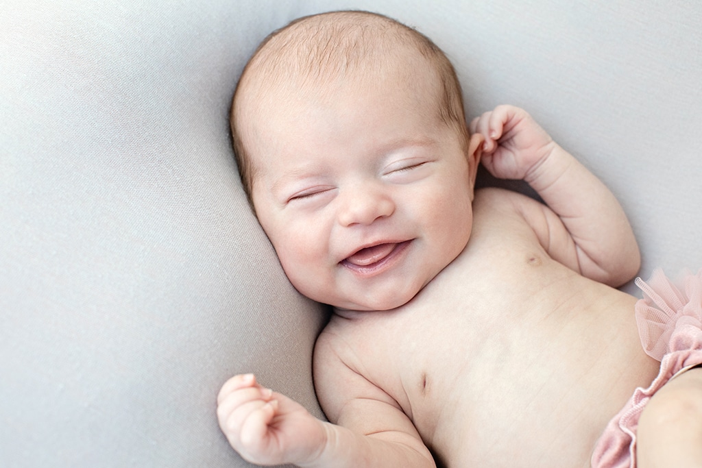 adorable newborn baby girl wide awake in private studio