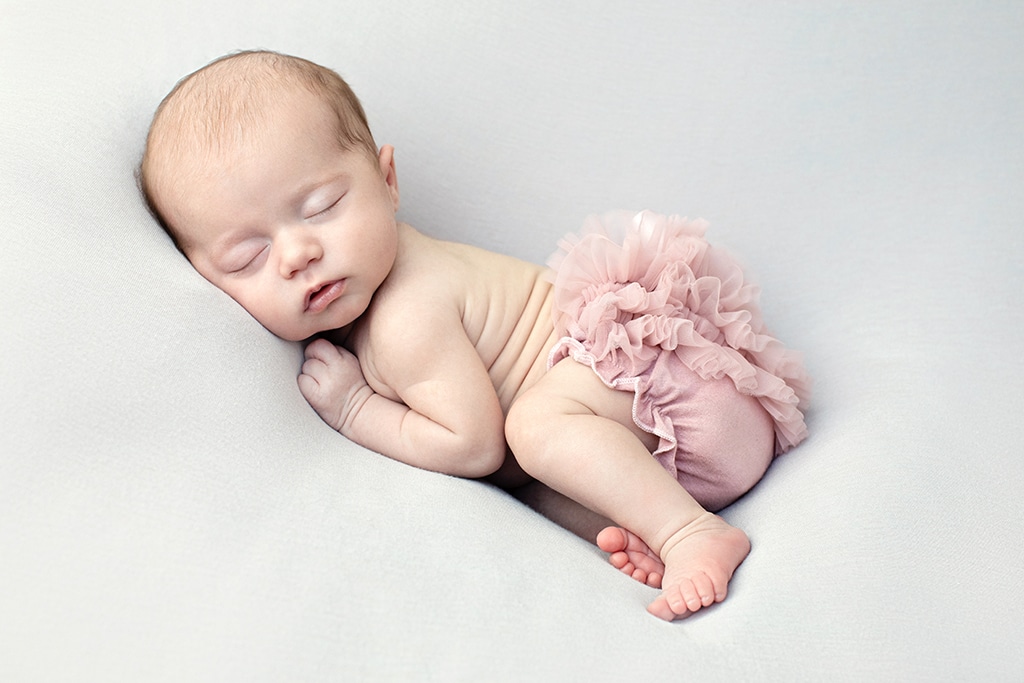 adorable baby girl wide awake in private studio