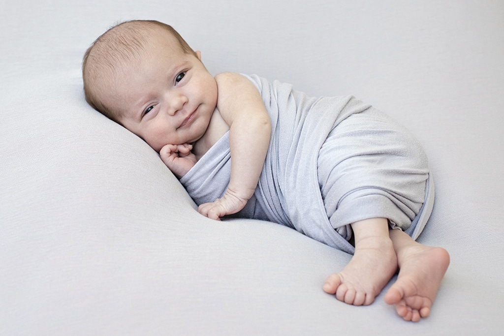 adorable newborn baby girl wide awake in private studio