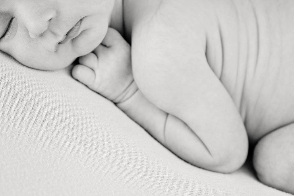 snuggled up newborn in beautiful black and white shot