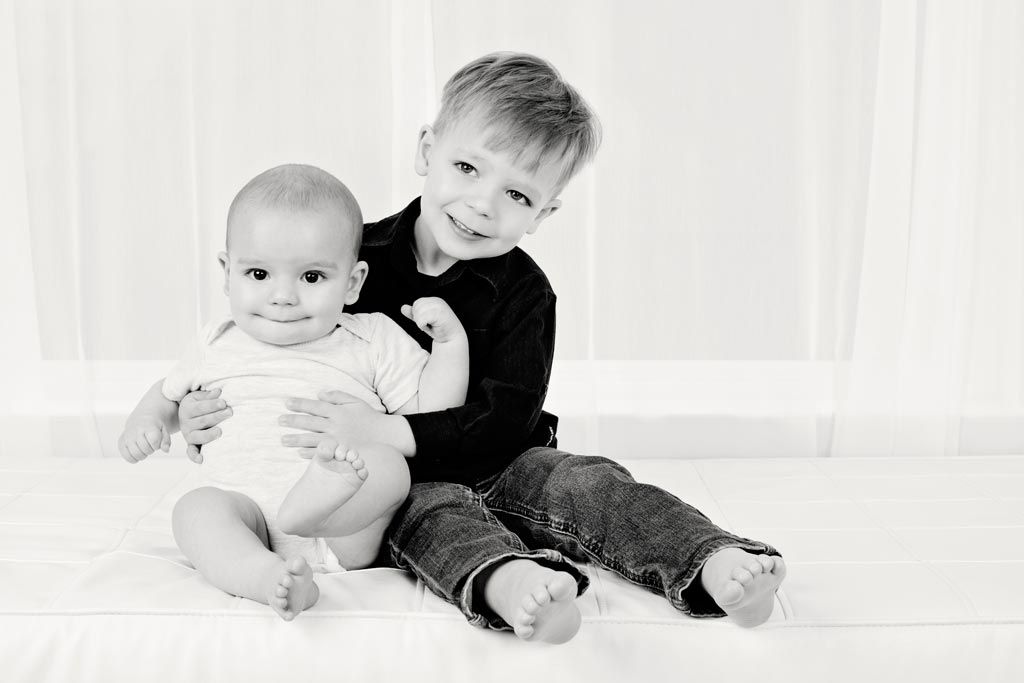 six-month old and his big brother pose in private studio for adorable and memorable photos