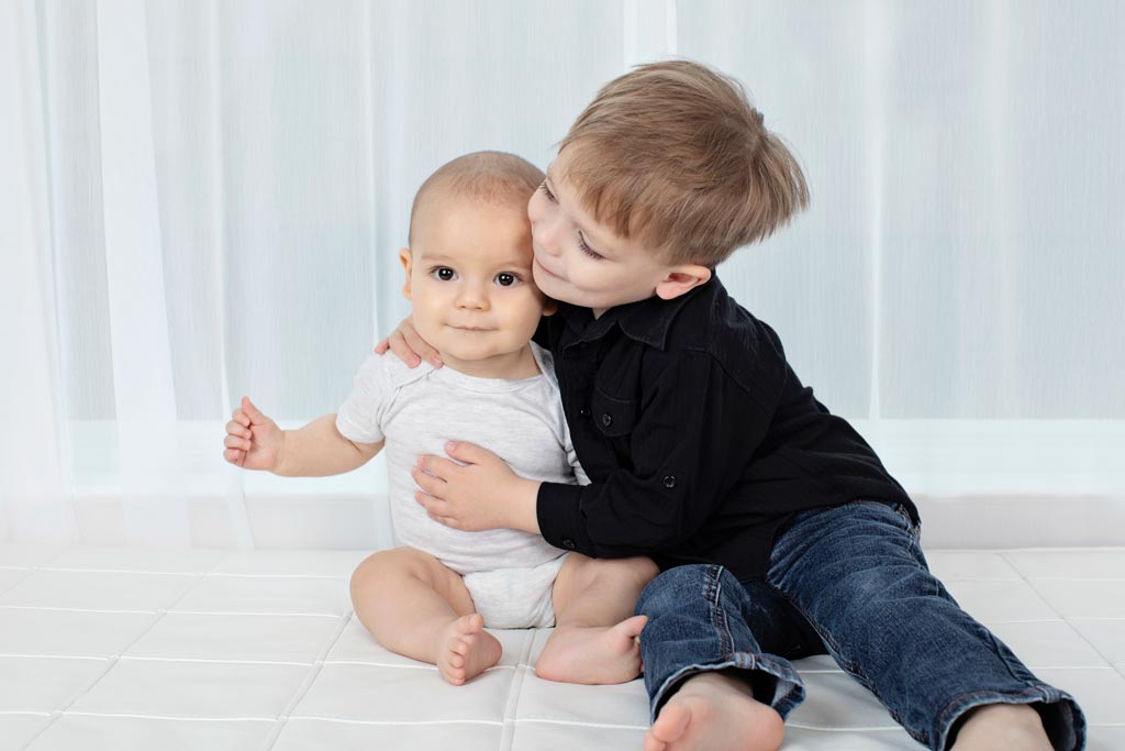 six-month old and his big brother pose in private studio for adorable and memorable photos