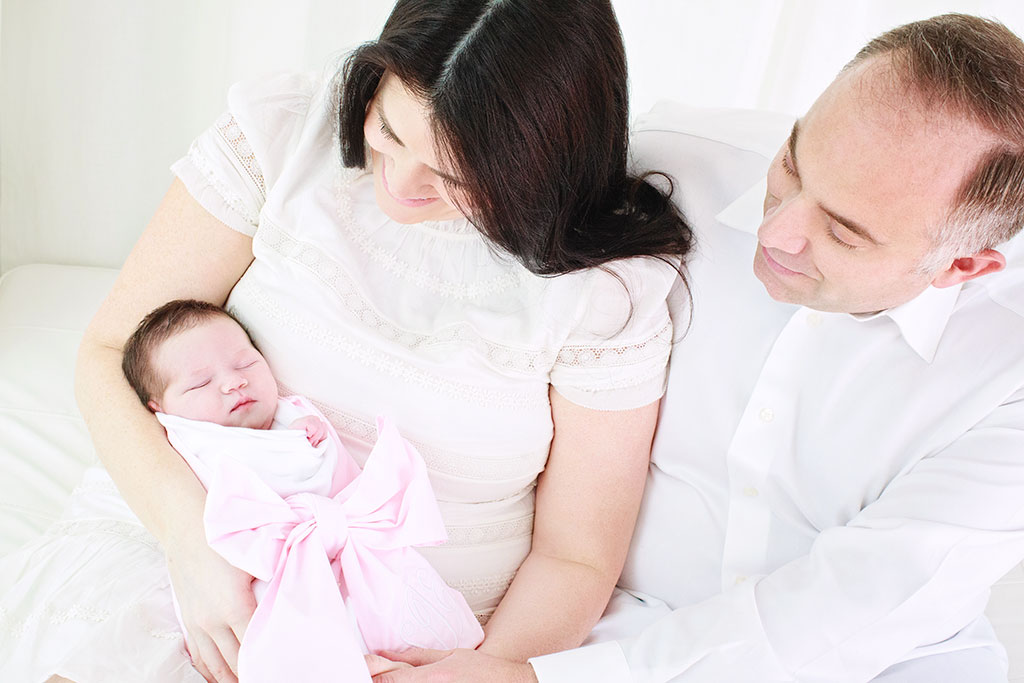 Beautiful first time parents with their little newborn girl