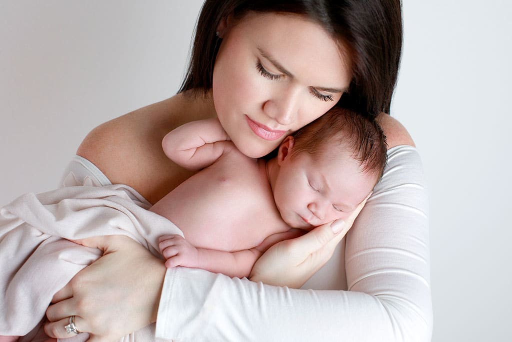 Beautiful first time parents with their little newborn girl