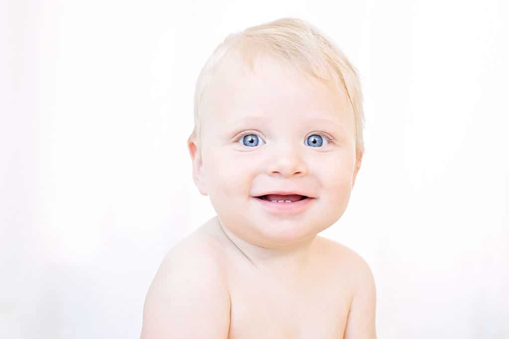 smiling six-month baby boy in the studio