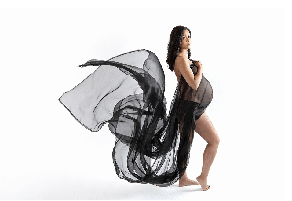 Pregnant mama in private dallas studio with dramatic and flowing dress