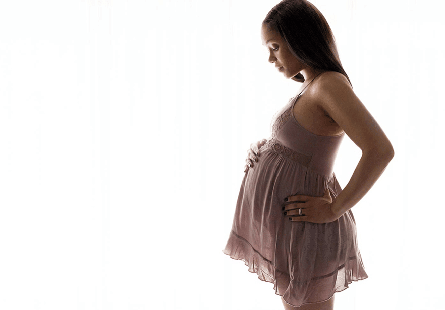 Pregnant mama in private dallas studio with dramatic and flowing dress