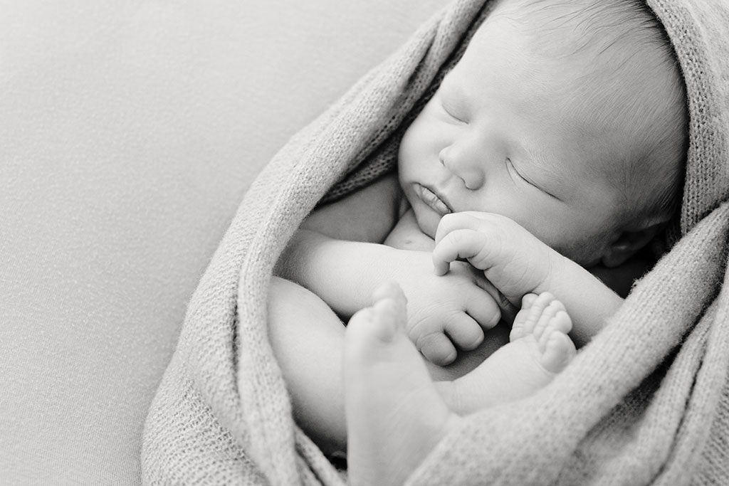 sweet tender baby all snuggled up for newborn session in private dallas studio