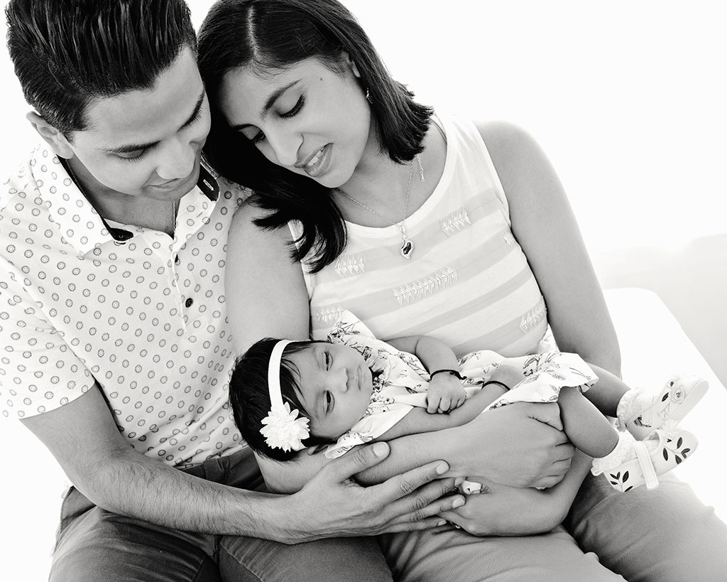 Beautiful 3-month-old baby girl in private studio session, with her parents