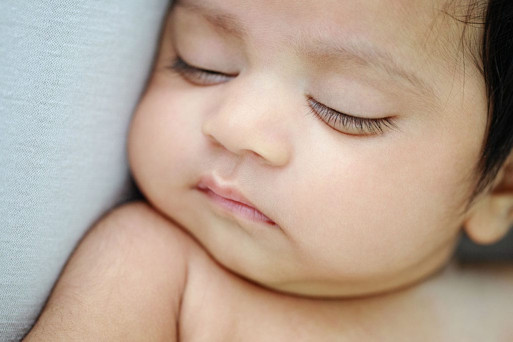 Beautiful 3-month-old baby girl in private studio session, with her parents