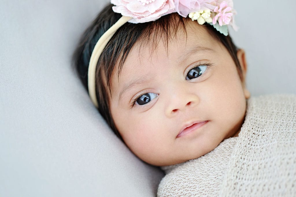 Beautiful 3-month-old baby girl in private studio session, with her parents