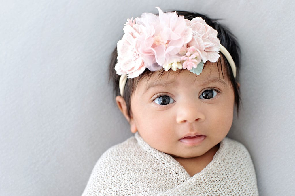 Beautiful 3-month-old baby girl in private studio session, with her parents